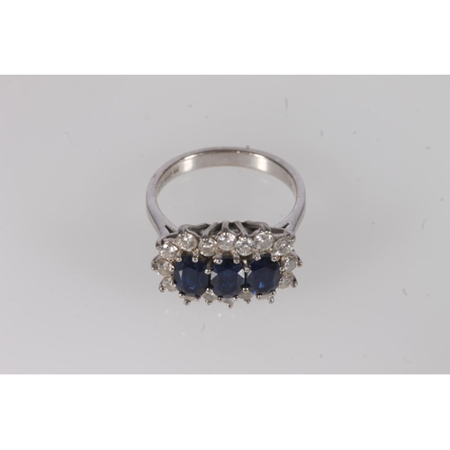 797 - 18ct white gold, sapphire and diamond cluster ring, the three oval cut sapphires framed on a bed of ... 