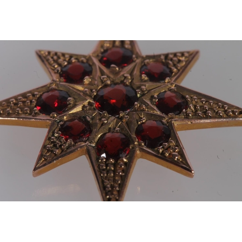 799 - Edwardian 9ct gold and garnet pendant, the round cut garnets with a star form mount, on fine yellow ... 