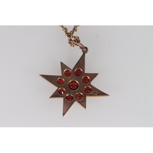 799 - Edwardian 9ct gold and garnet pendant, the round cut garnets with a star form mount, on fine yellow ... 