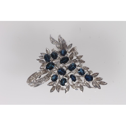 801 - Silver backed sapphire and diamond brooch, the oval sapphires framed by small diamonds on a floral a... 