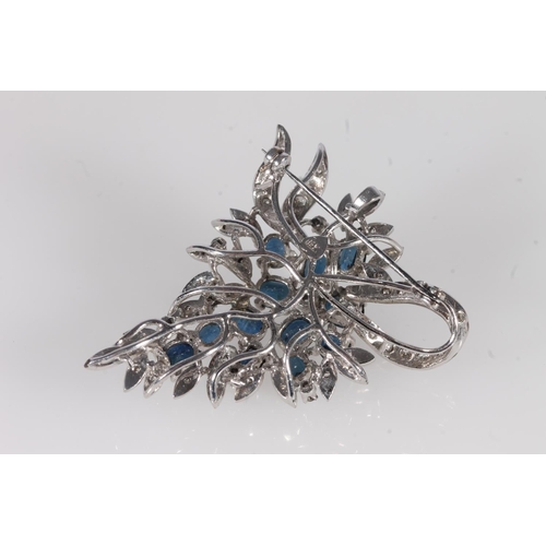 801 - Silver backed sapphire and diamond brooch, the oval sapphires framed by small diamonds on a floral a... 