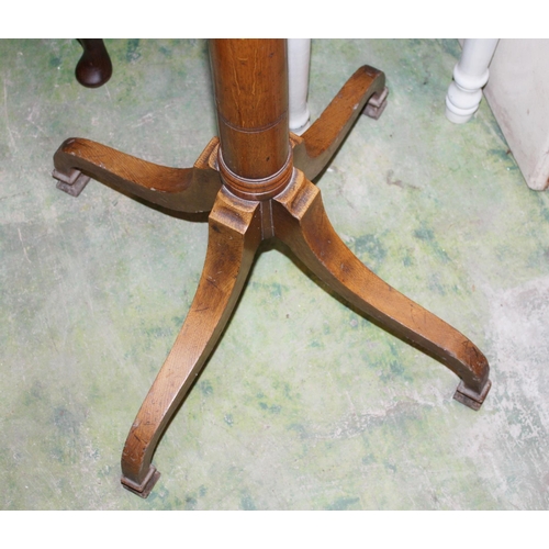 898 - Oak turned pillar hat and coat stand raised on quadripartite base, 182cm tall.