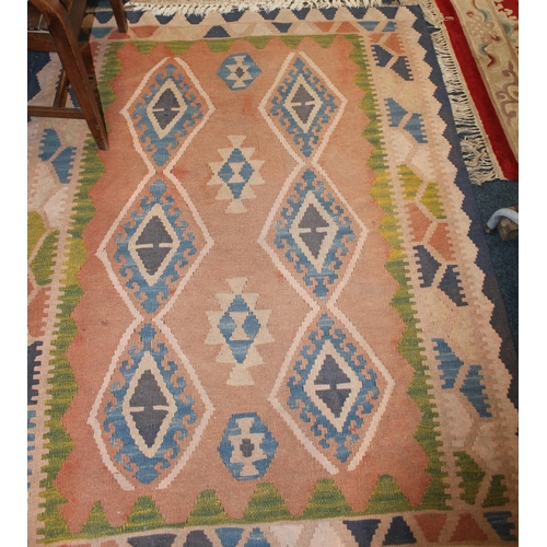 970 - Orange ground rug with geometric decoration, a beige ground rug and a red ground prayer matt. (3)