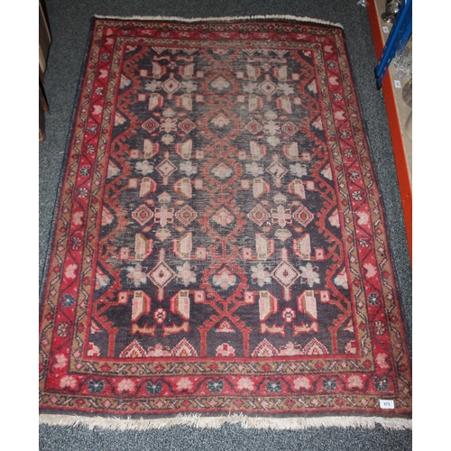 975 - Red ground multiple border fringed rug.