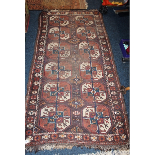 979 - Brown ground geometric pattern fringed rug, 200cm x 100cm.