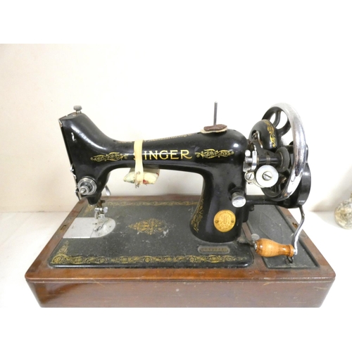 421 - Cased Singer sewing machine.