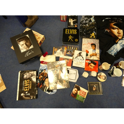 516 - Large box of Elvis memorabilia including records, t-shirts, mugs etc.