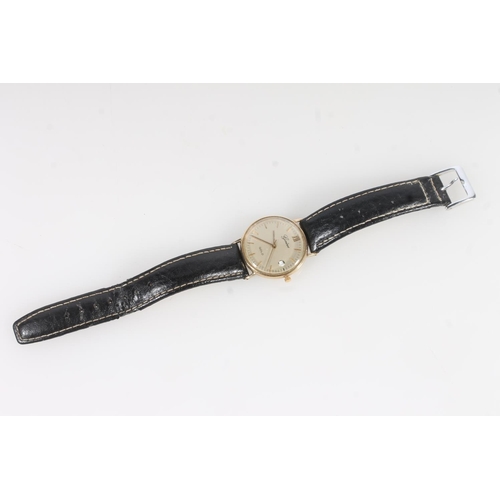 766 - 9ct gold Geneve gold gents wristwatch on black leather strap.