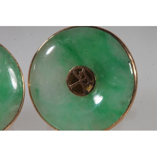 783 - A pair of Chinese jade earrings set in yellow metal, 4.9g.