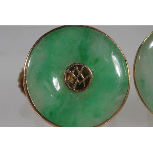 783 - A pair of Chinese jade earrings set in yellow metal, 4.9g.