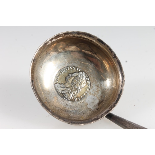 827 - Antique silver balleen handled toddy lift, the bowl with central silver coin.