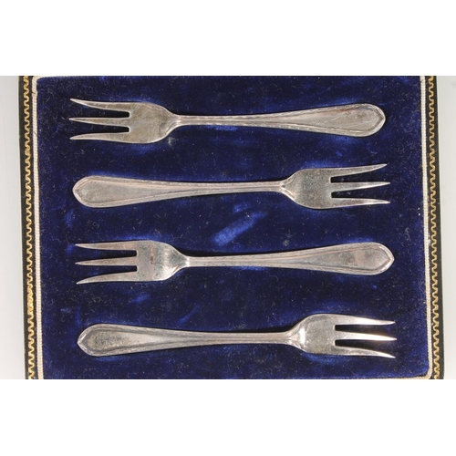 831 - Cased set of four sterling silver pickle forks, Cooper Bros & sons, Sheffield and two silver spo... 