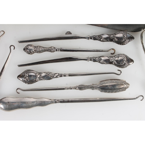 844 - Collection of silver handled and other button hooks, shoehorns, ebonised glove stretchers etc.