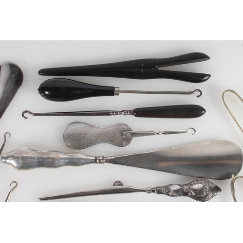 844 - Collection of silver handled and other button hooks, shoehorns, ebonised glove stretchers etc.