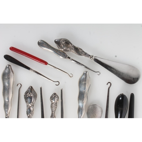 844 - Collection of silver handled and other button hooks, shoehorns, ebonised glove stretchers etc.