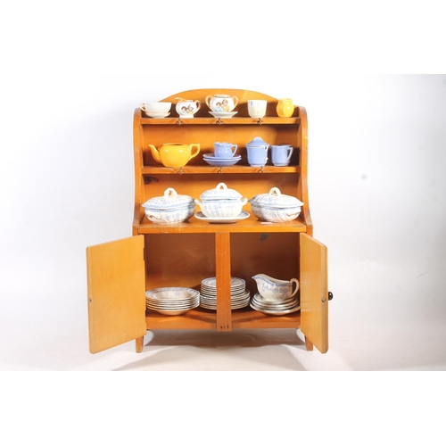 10 - Child's pottery teasets and tea ware, and a nursery rhyme decorated child's cabinet.