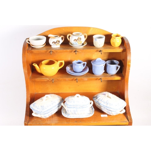 10 - Child's pottery teasets and tea ware, and a nursery rhyme decorated child's cabinet.