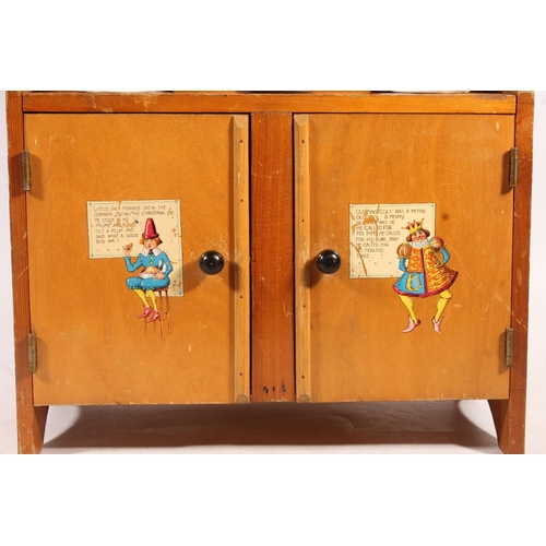 10 - Child's pottery teasets and tea ware, and a nursery rhyme decorated child's cabinet.