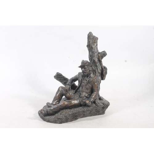 24 - John Letts bronzed resin sculpture of a man by a tree, 28cm high.