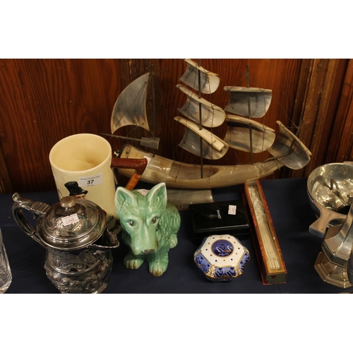 37 - Horn model of a ship, a Sylvac green pottery terrier model, a fan, a silver-plated jug, etc.