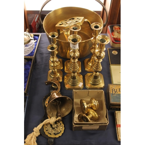 71 - Brass ware to include a jam pan, trivets, candlesticks, and other metalware.