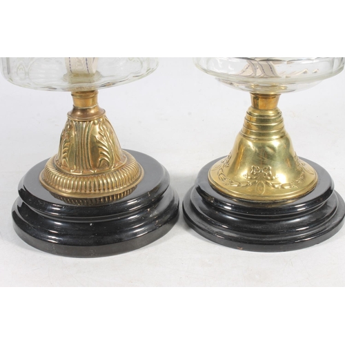 188 - Two Victorian glass oil lamps on brass columns and ebonised terracotta bases.