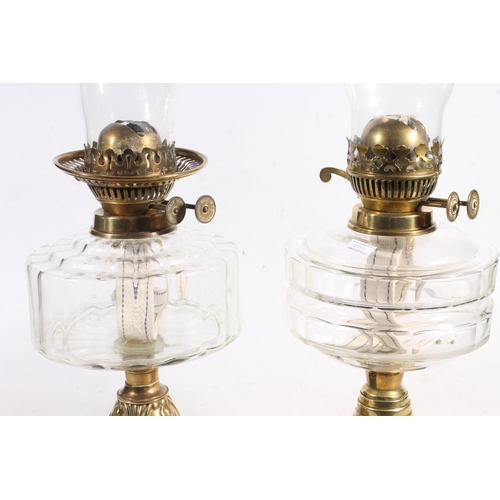 188 - Two Victorian glass oil lamps on brass columns and ebonised terracotta bases.