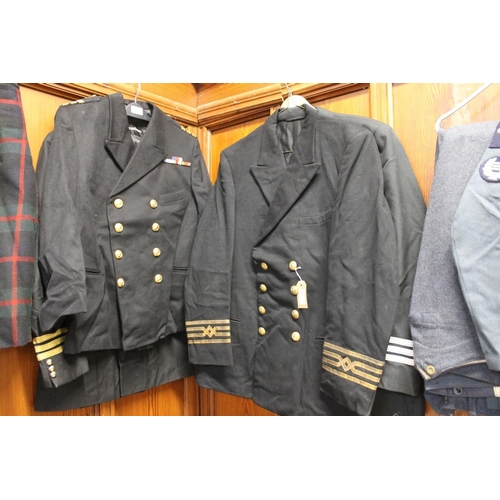 206 - Four black cloth military jackets to include one with Trinity House Pilot Service buttons, a Naval V... 