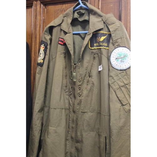 210 - British Naval black cloth long coat with brass buttons and similar cap, also a khaki flying suit.