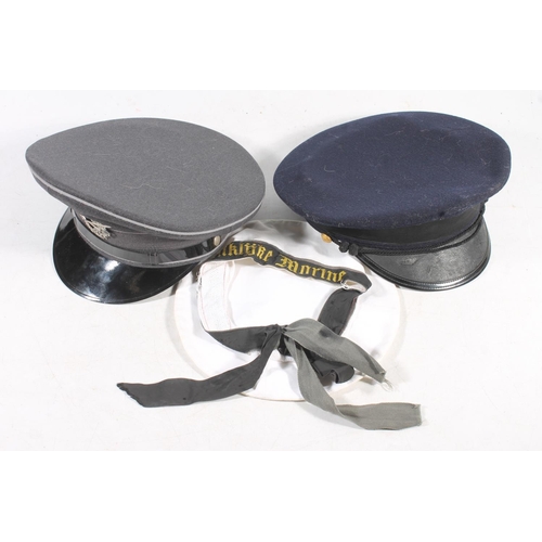 212 - Reproduction German peaked cap with crossed swords cap badge, a German sailor's cap and another peak... 