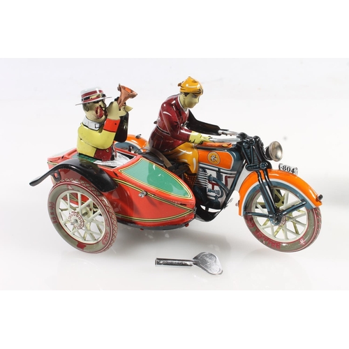 248 - Three clockwork tinplate style models to include a motorbike and sidecar, a gentleman with suitcase ... 