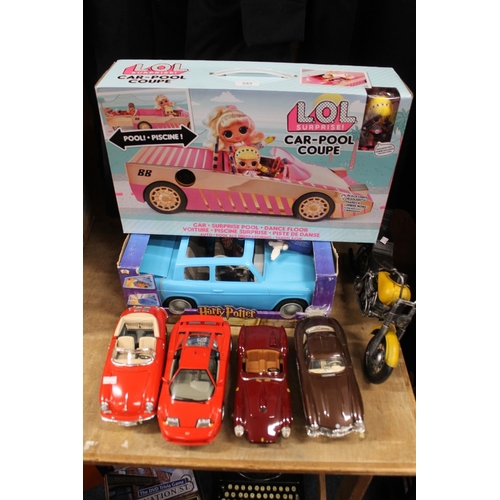 253 - Toys to include an LOL Surprise car coupe, a Harry Potter Weasley flying car, boxed, a model motorbi... 