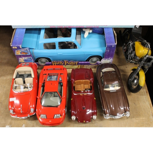 253 - Toys to include an LOL Surprise car coupe, a Harry Potter Weasley flying car, boxed, a model motorbi... 