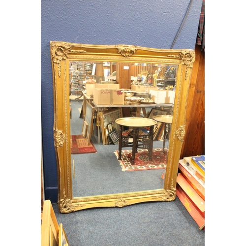 981 - Large bevel edged gilt framed wall mirror, 116cm x 145cm.