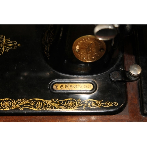 402 - Cased Singer sewing machine.