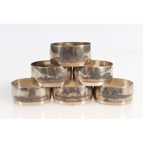 806 - Set of six Iraqi white metal Niello napkin rings with river and landscape decoration.