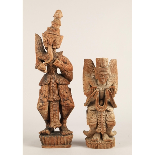 37 - Two Eastern carved wooden figures. 49cm and 31cm