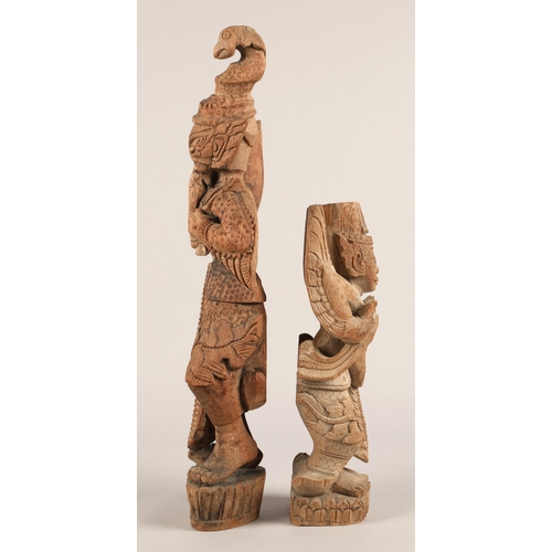 37 - Two Eastern carved wooden figures. 49cm and 31cm