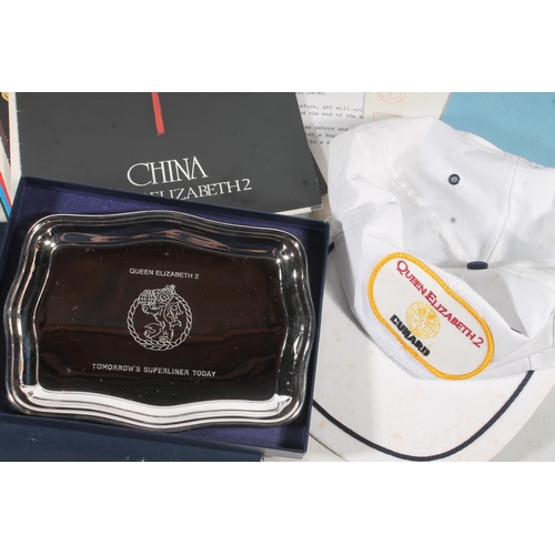 648 - Cunard collectibles to include The Legend of Queen Elizabeth II coin, EPNS tray boxed, EPNS napkin r... 