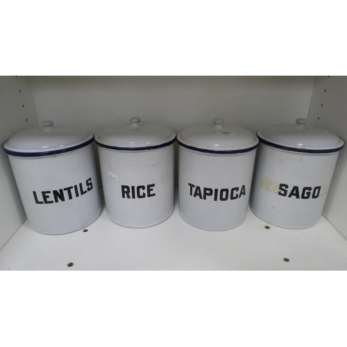 102 - Set of four enamel storage jars to include 'Lentils', 'Rice', 'Tapioca' and 'Sago' (one shelf).  (4)