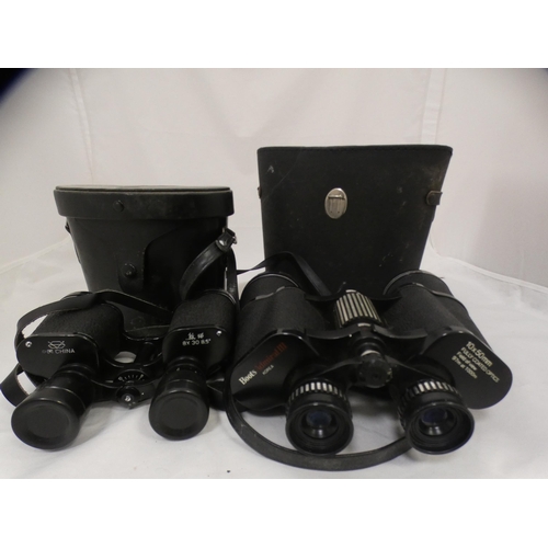 134 - Two cased sets of binoculars.