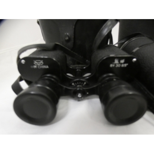 134 - Two cased sets of binoculars.