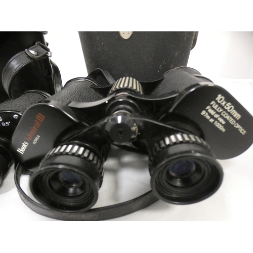 134 - Two cased sets of binoculars.