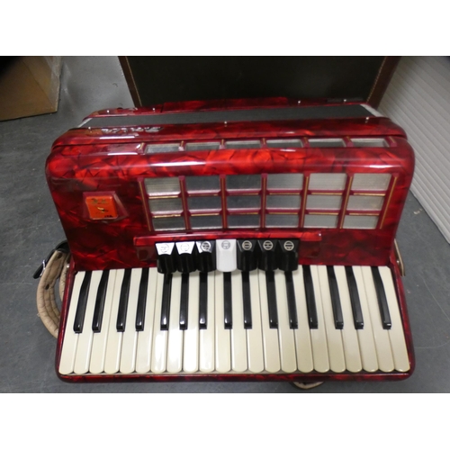 142 - Red lustre Baile Celeste accordion, cased.