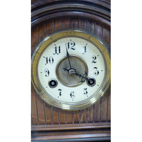 17 - Antique oak-cased mantel clock.