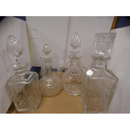 207A - Five assorted glass decanters and a jug.