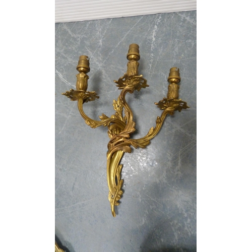 21 - Five gilded triple-branch wall sconces.