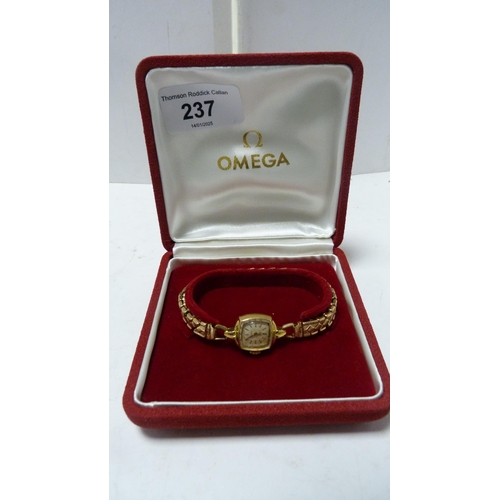 237 - Omega 18ct gold lady's wristwatch on gilt metal expanding bracelet.