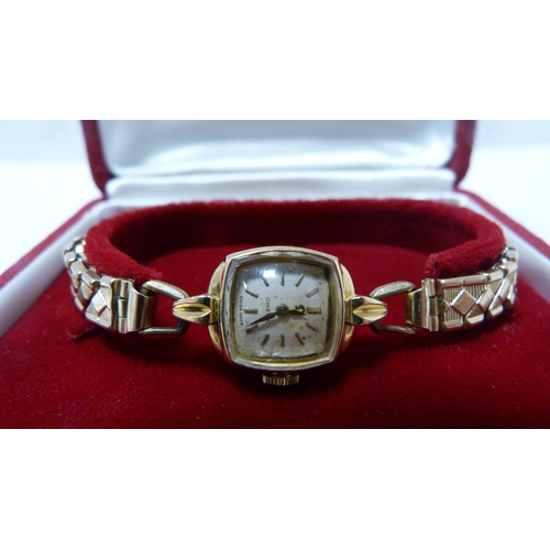 237 - Omega 18ct gold lady's wristwatch on gilt metal expanding bracelet.