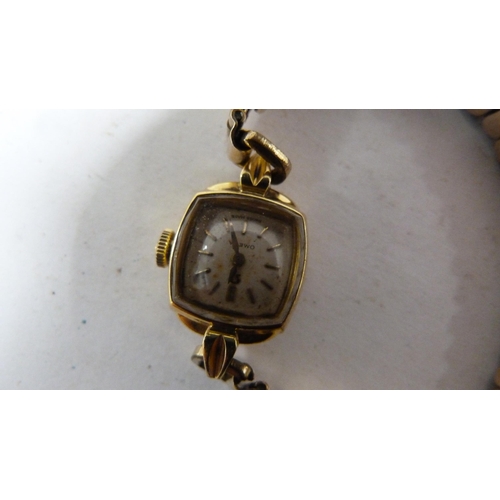 237 - Omega 18ct gold lady's wristwatch on gilt metal expanding bracelet.